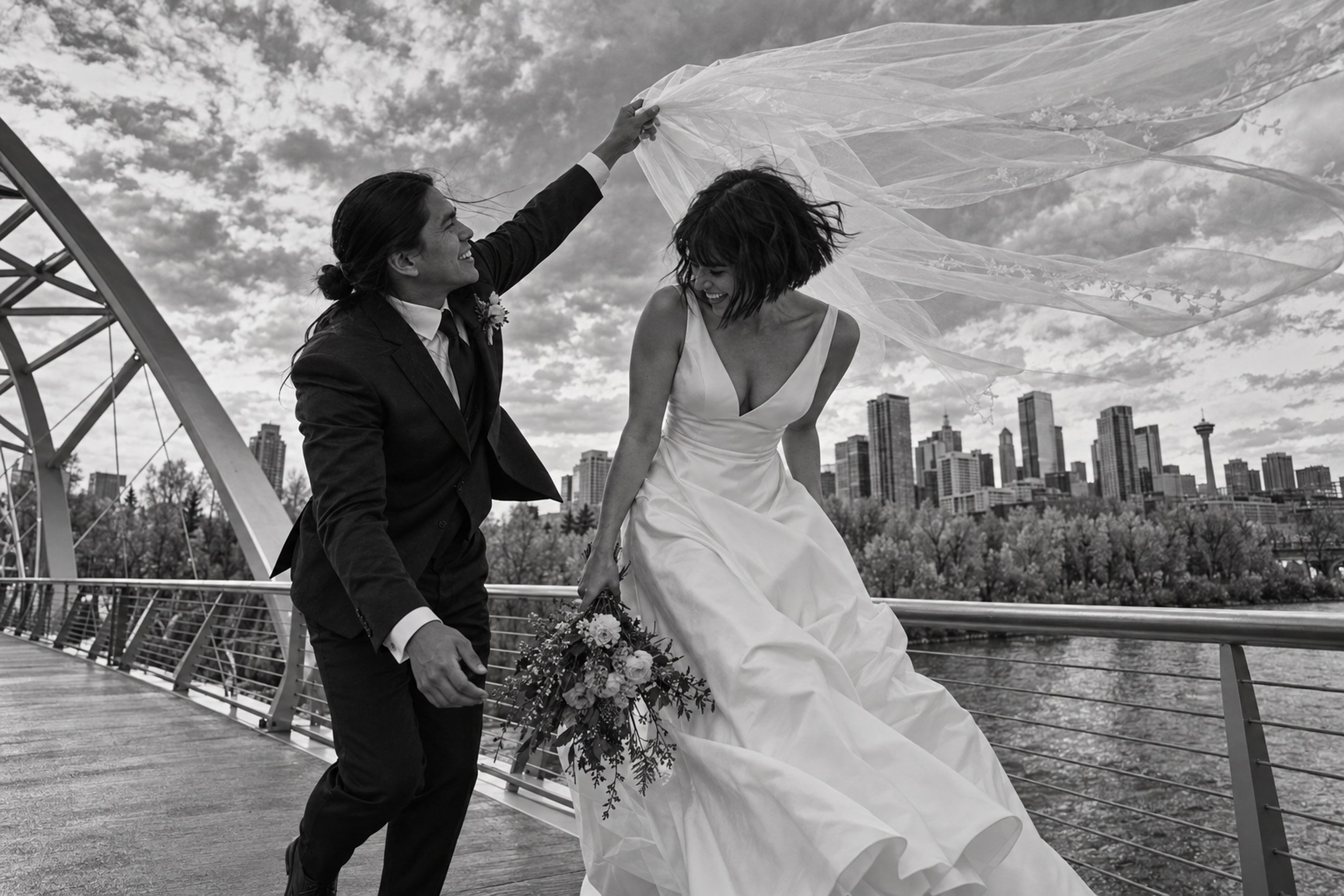 Newlyweds crossing a bridge in Calgary's East Village